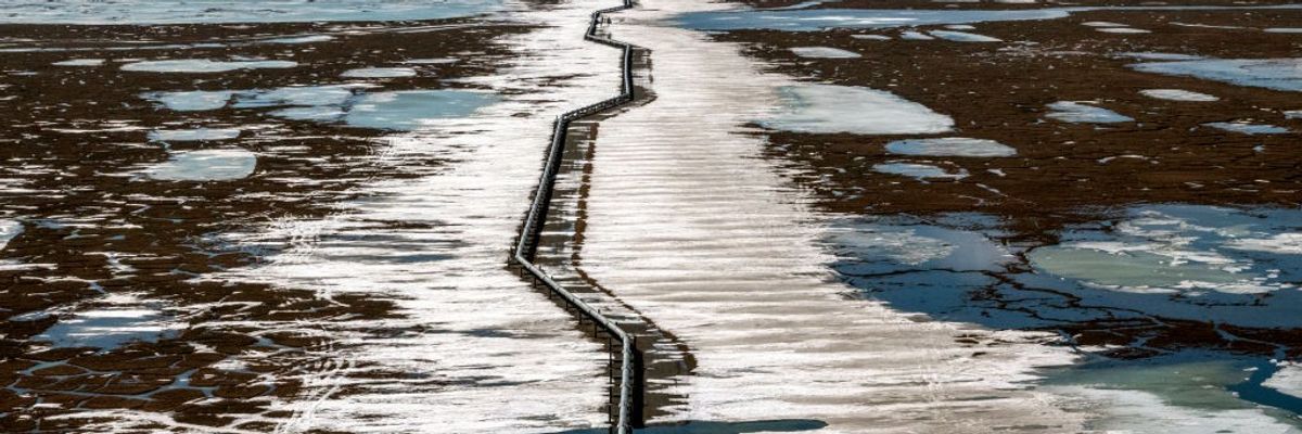 An oil pipeline stretches across the landscape outside Prudhoe Bay in North Slope Borough, Alaska on May 25, 2019.
