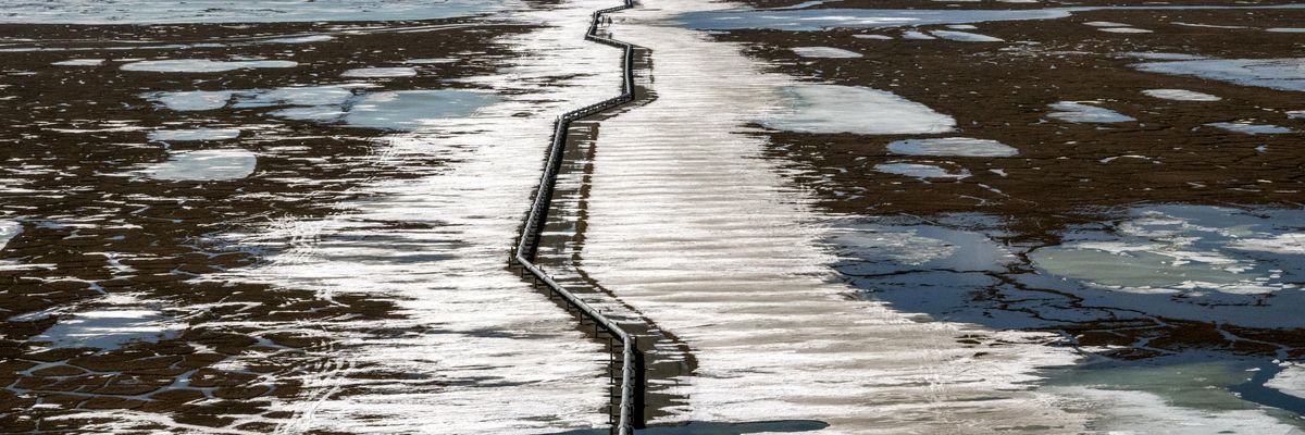 An oil pipeline stretches across the landscape outside Prudhoe Bay in North Slope Borough, Alaska