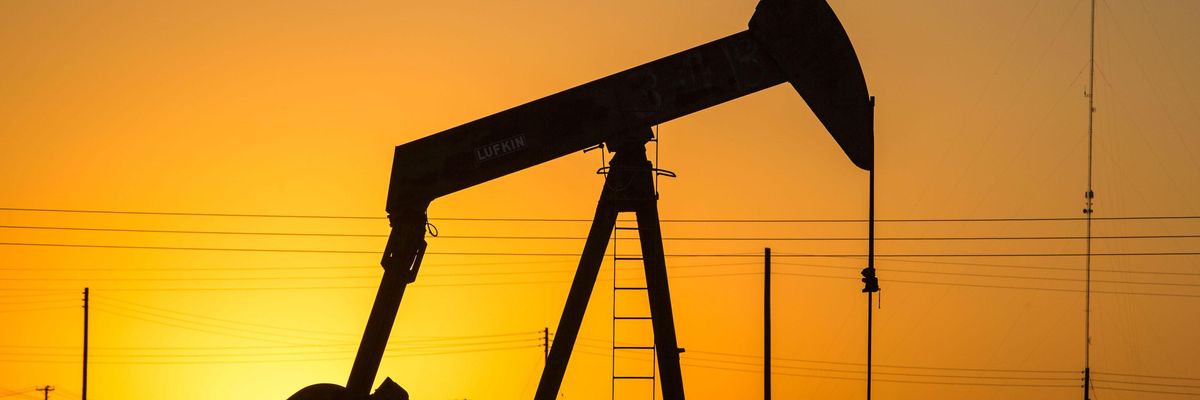 An oil pumpjack is silhouetted against the morning sunrise on July 8, 2021, north of Bakersfield, California.