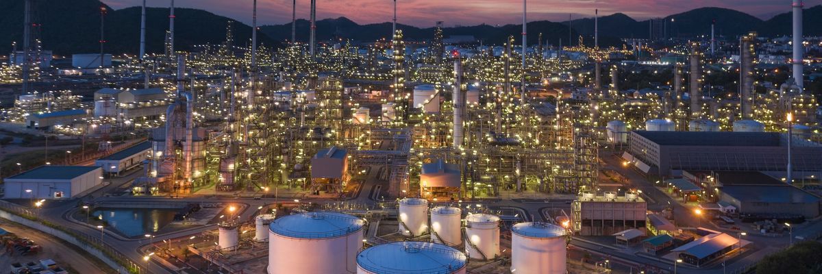 An oil refinery is shown at dusk in Thailand.