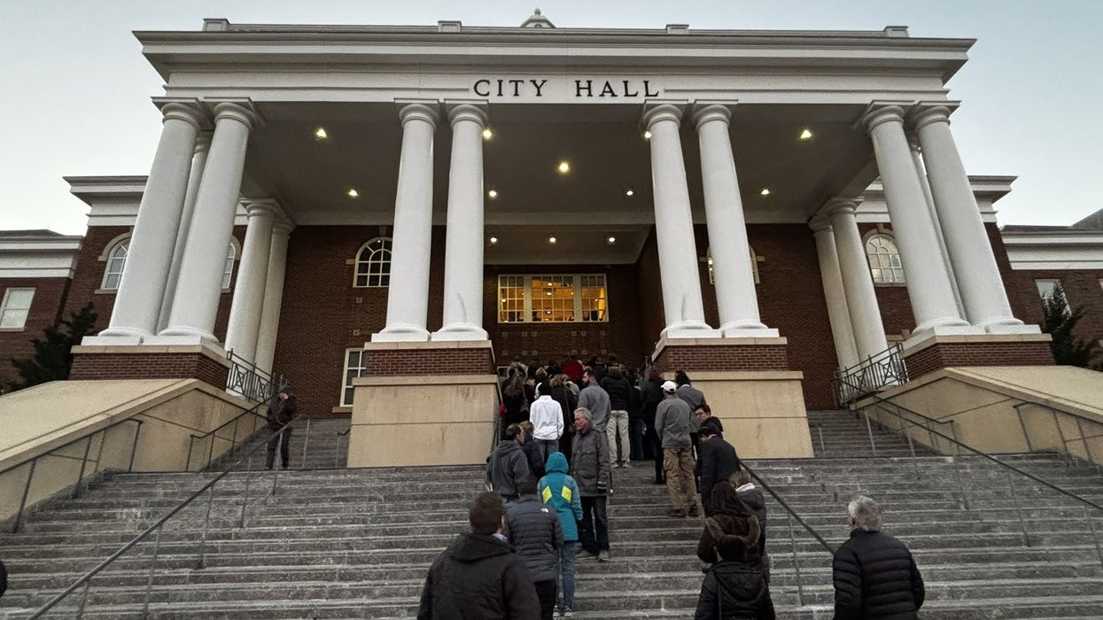 An overflow crowd spills outside the Roswell City Hall