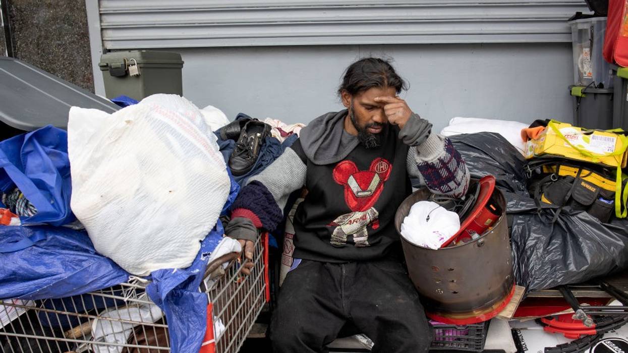 An unhoused man is distraught as he is forced to dismantle his home and possessions in New York City