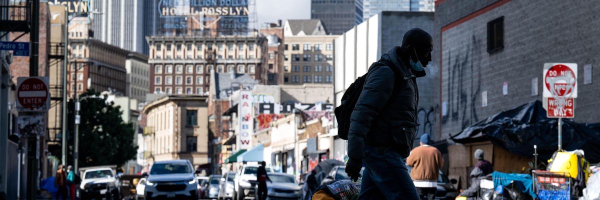 An unhoused man walks through Skid Row in Los Angeles on December 12, 2022.
