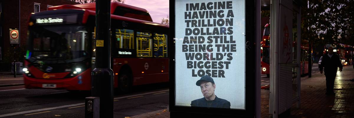 An unofficially installed poster that reads, "Imagine having a trillion dollars and still being the world's biggest loser,"