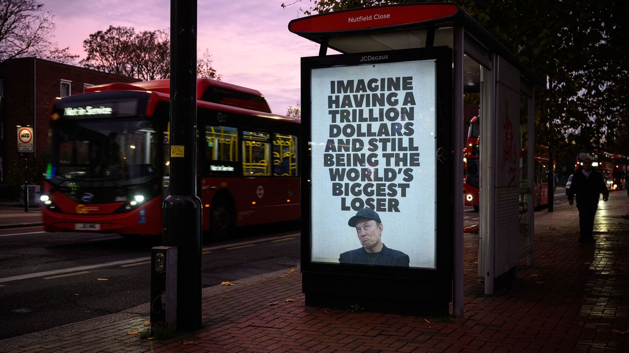 An unofficially installed poster that reads, "Imagine having a trillion dollars and still being the world's biggest loser,"