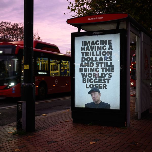 An unofficially installed poster that reads, "Imagine having a trillion dollars and still being the world's biggest loser,"