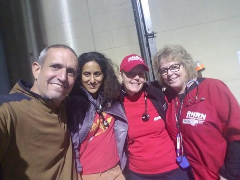Andy Bichlbaum and Rupa Marya (second from left), along with nurses in the makeshift clinic at the Casino Pavilion. (WNV / Andy Bichlbaum)