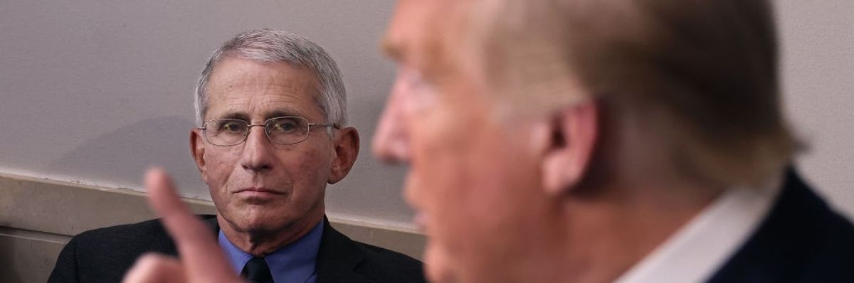 Anthony Fauci listens to President Donald Trump on April 7, 2020