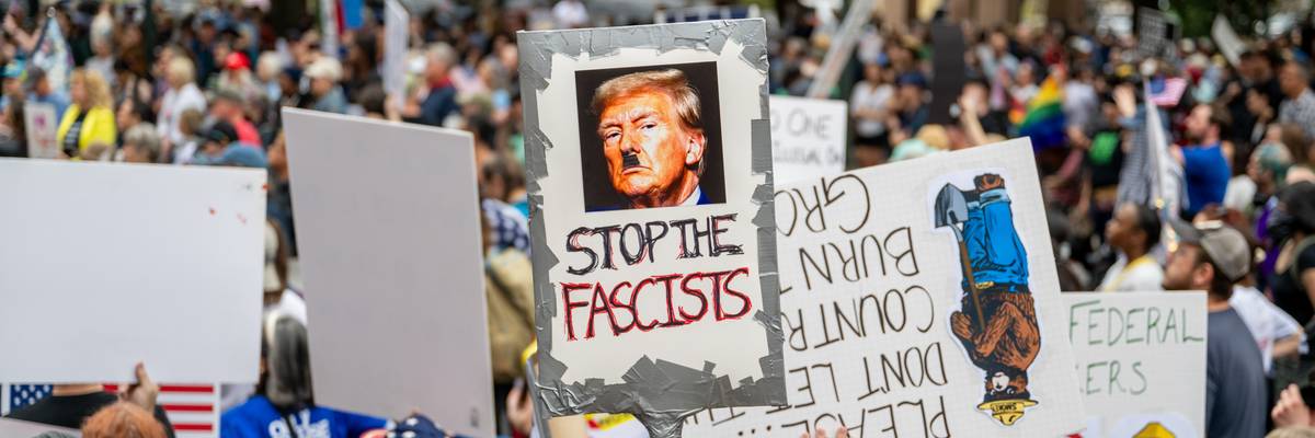 Anti-Trump protest with sign saying, "Stop the fascists."
