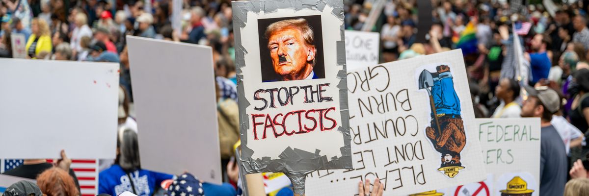 Anti-Trump protest with sign saying, "Stop the fascists."