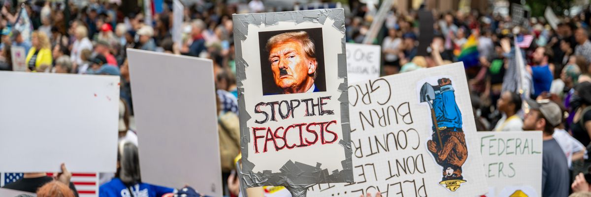Anti-Trump protest with sign saying, "Stop the fascists."