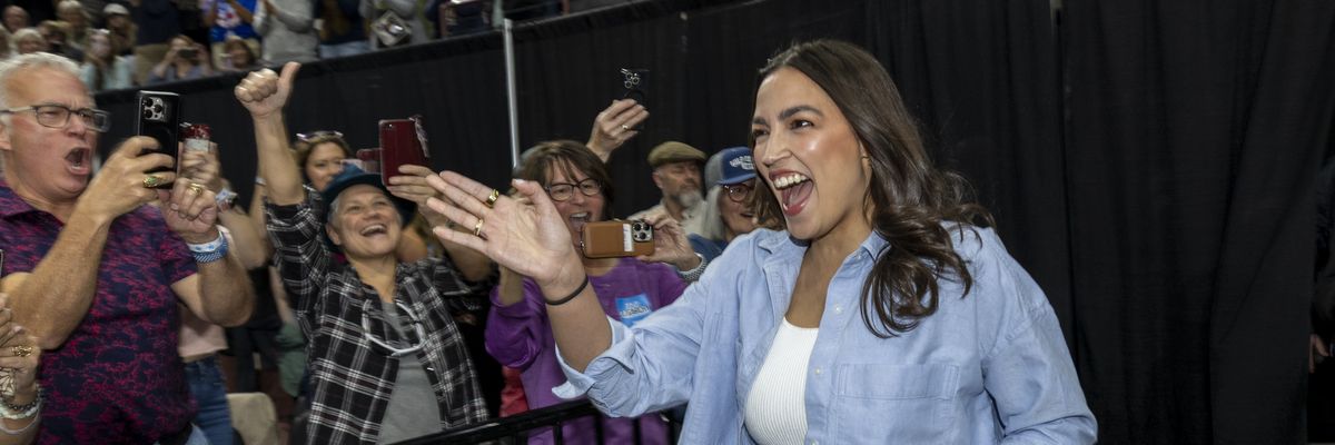 AOC waves to attendees