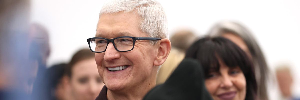 Apple CEO Tim Cook walks through a crowd during an event