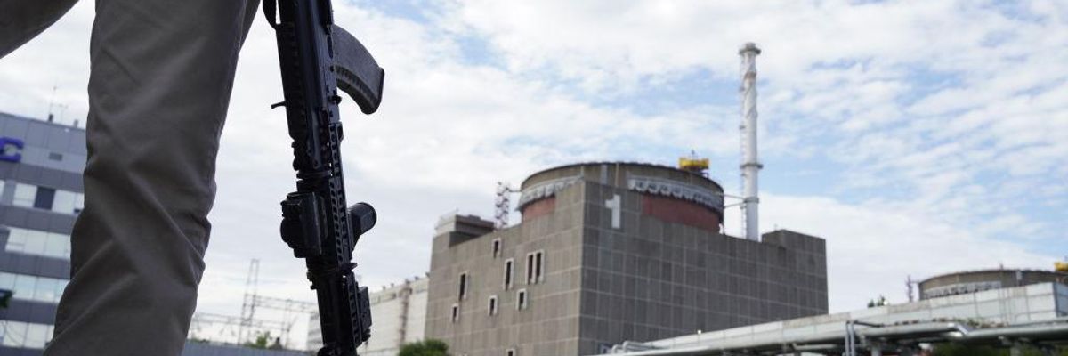 armed person stands near Ukrainian nuclear power plant
