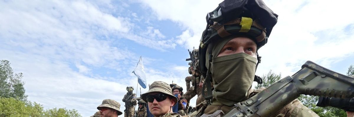 Armed soldiers in field.