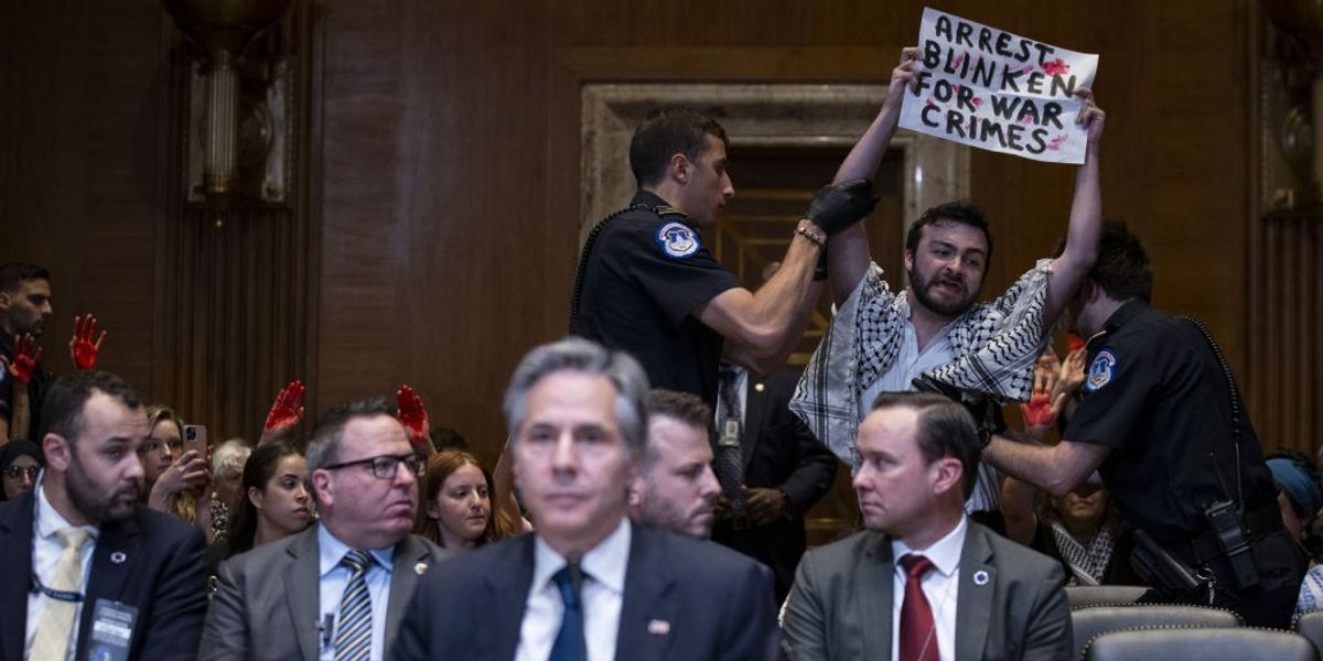 'Arrest Blinken for War Crimes' says protesters sign