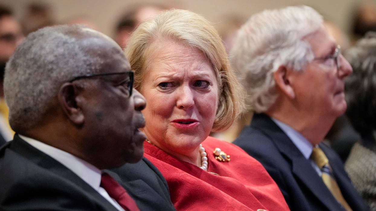 Associate Supreme Court Justice Clarence Thomas sits with his wife, conservative activist Ginni Thomas, while he waits to speak at the Heritage Foundation on October 21, 2021 in Washington, D.C.