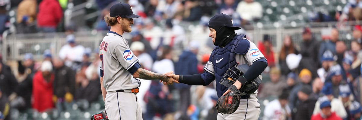 Astros shake hands with Occidental Petroleum label on their uniform sleeves.