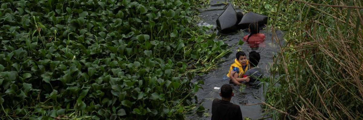 Asylum seekers cross the Rio Grande into Brownsville, Texas