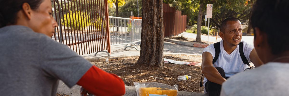 Asylum-seekers sit outside the San Antonio Migrant Resource Center on September 19, 2022. Florida Gov. Ron DeSantis has used the false promise of refugee resettlement benefits to lure immigrants onto flights from the center in Texas to Martha's Vineyard in Massachusetts.