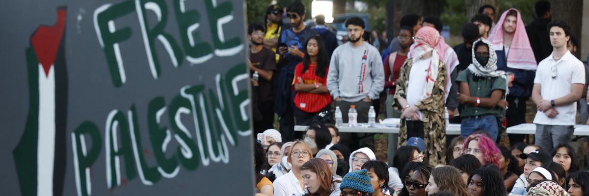 Attendees gather for a vigil organized by the Students for Justice in Palestine at the University of Maryland
