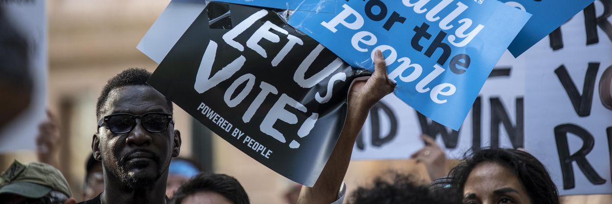 Attendees hold up signs during a rally at the state Capitol on June 20, 2021, in Austin, Texas.