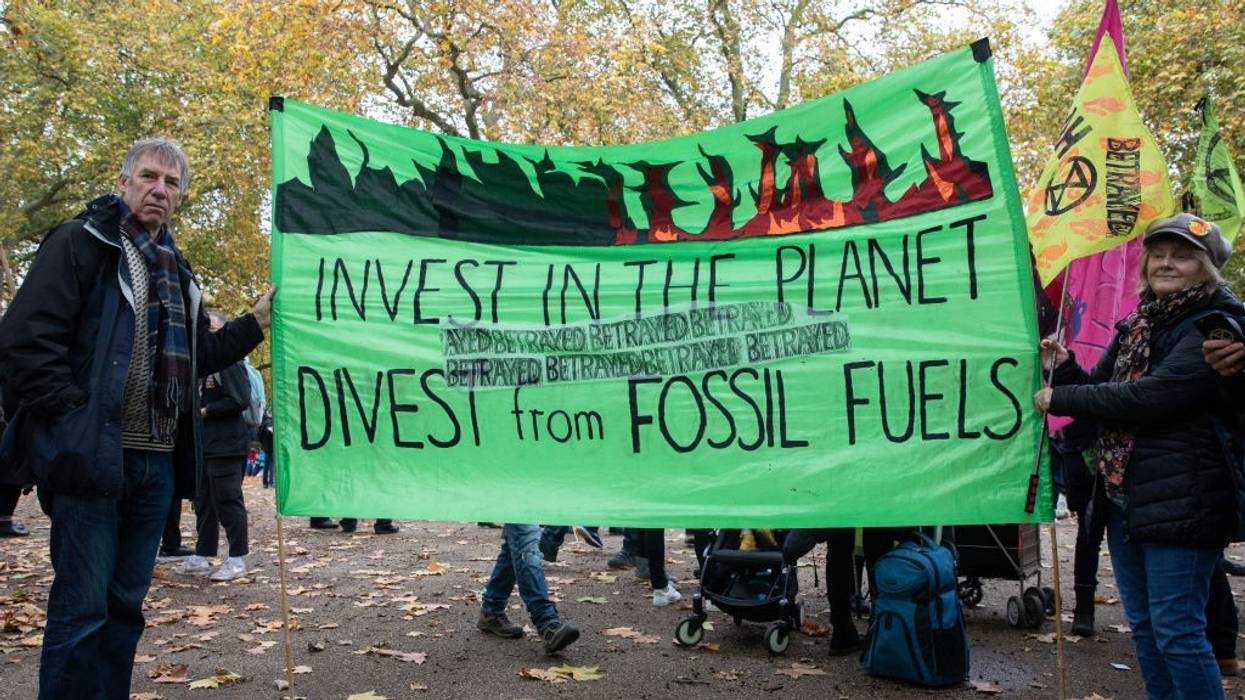 Banner says, "Invest in the planet, divest from fossil fuels."