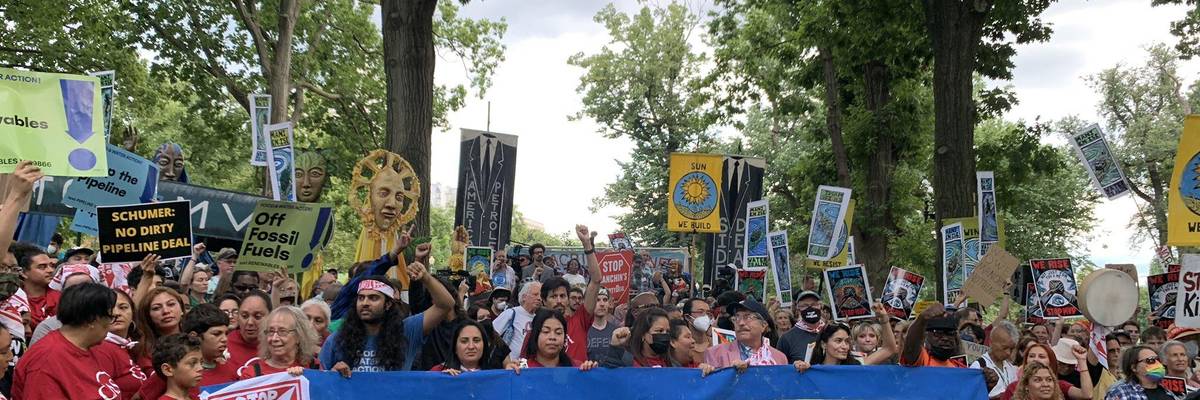 banner says "senator schumer: kill the dirty pipeline deal"