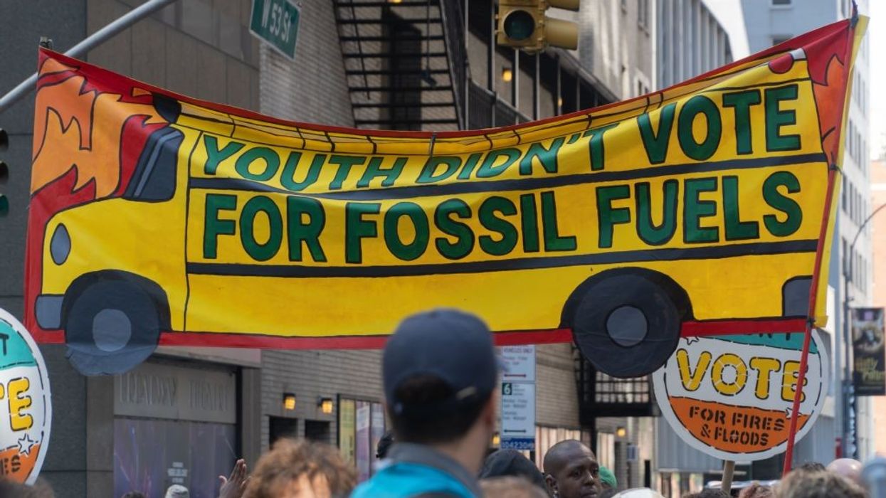 Banner, with school bus design, reads Youth Didn't Vote For Fossil Fuels, March to End Fossil Fuels