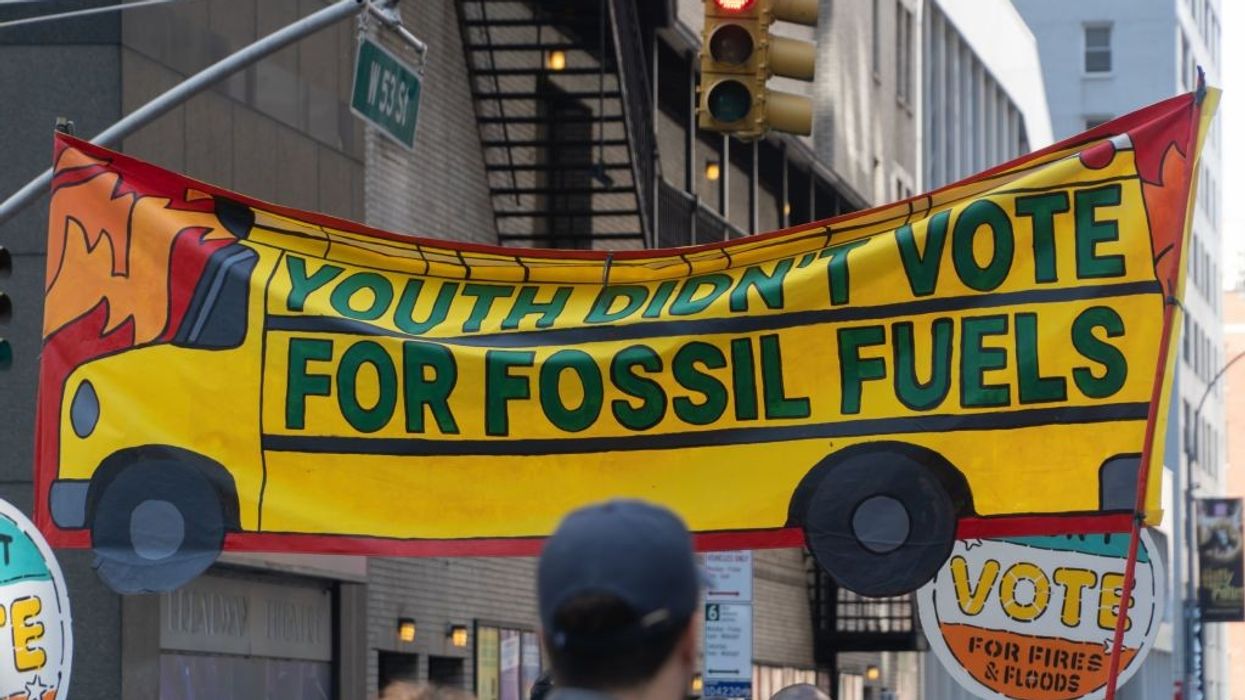 Banner, with school bus design, reads Youth Didn't Vote For Fossil Fuels, March to End Fossil Fuels