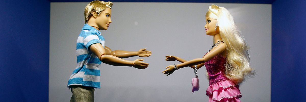 Barbie and Ken dolls reach out for each other