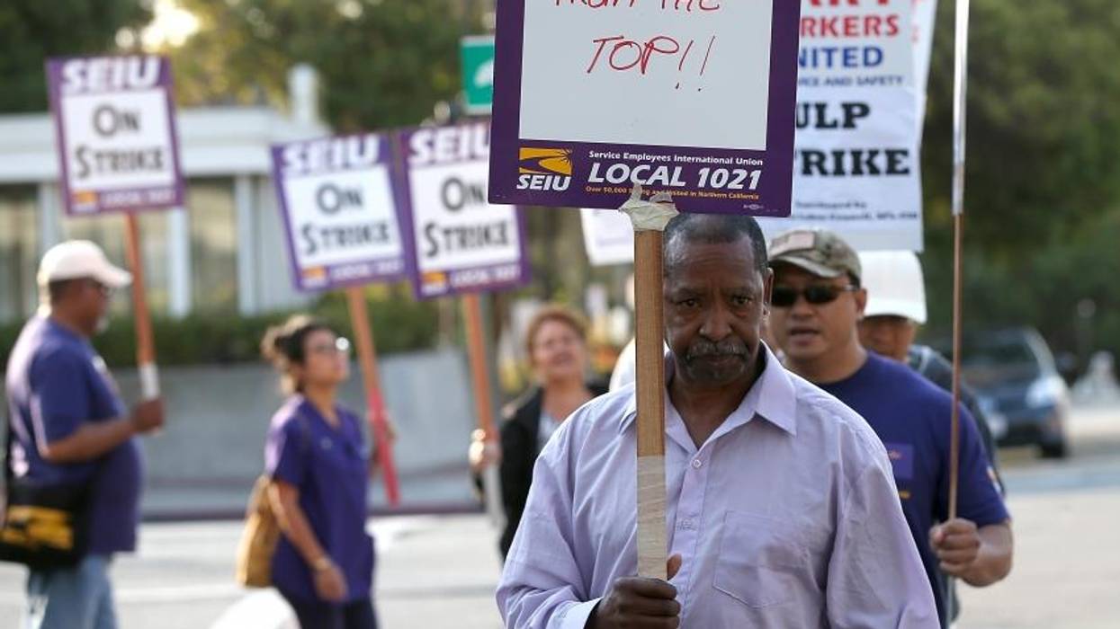 Bay Area Rapid Transit (BART) union workers with SEIU Local 1021 hold signs as they picket in front of the Lake Merritt station on July 2, 2013 in Oakland, California