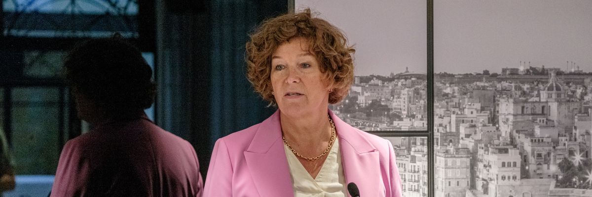 Belgian Deputy Prime Minister Petra De Sutter speaks, wearing a pink blazer and white blouse.