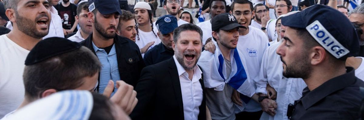 Bezalel Smotrich, wearing a suit without a tie, smiles during the Jerusalem Flag Day march