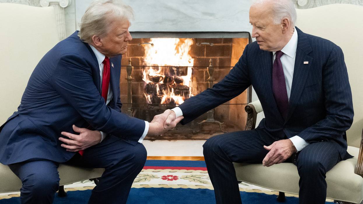 Biden and Trump shake hands.