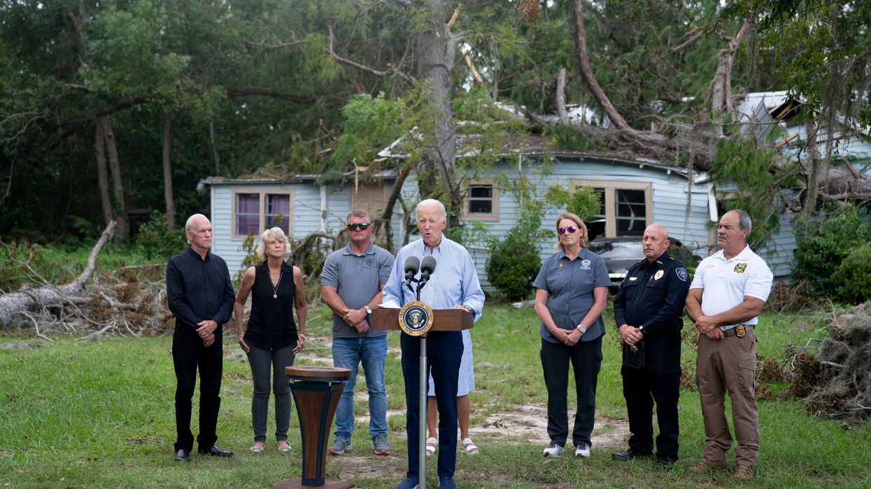 Biden speaks in front of a home destroyed by a hurricane