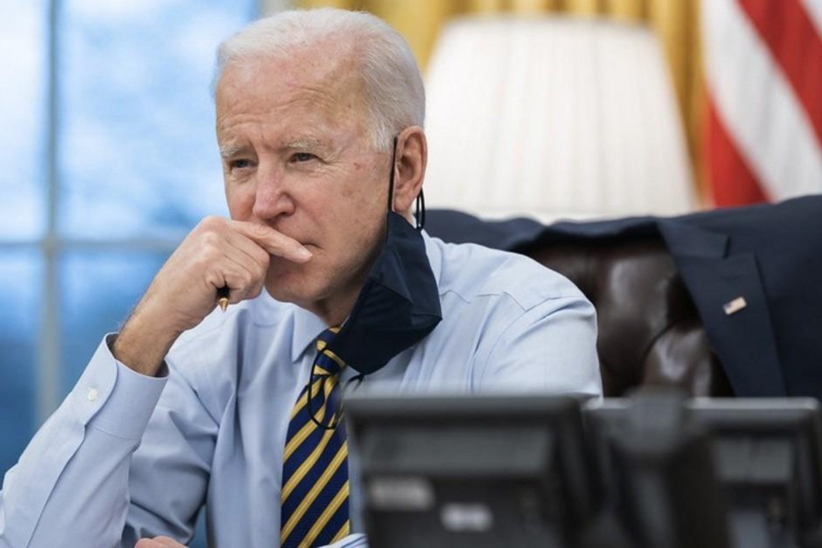 Biden with hand on face.