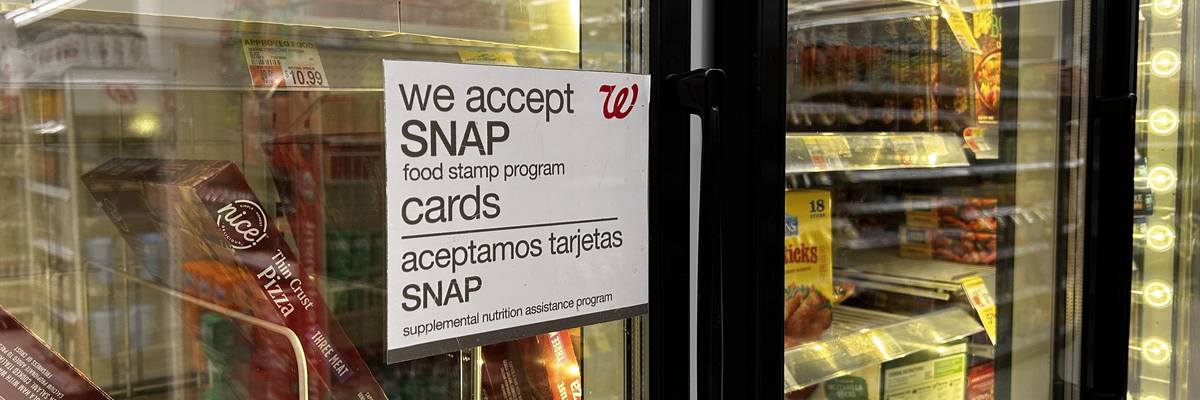 Bilingual sign on door of frozen food aisle, We accept SNAP food stamp cards, Walgreens, Queens, New York