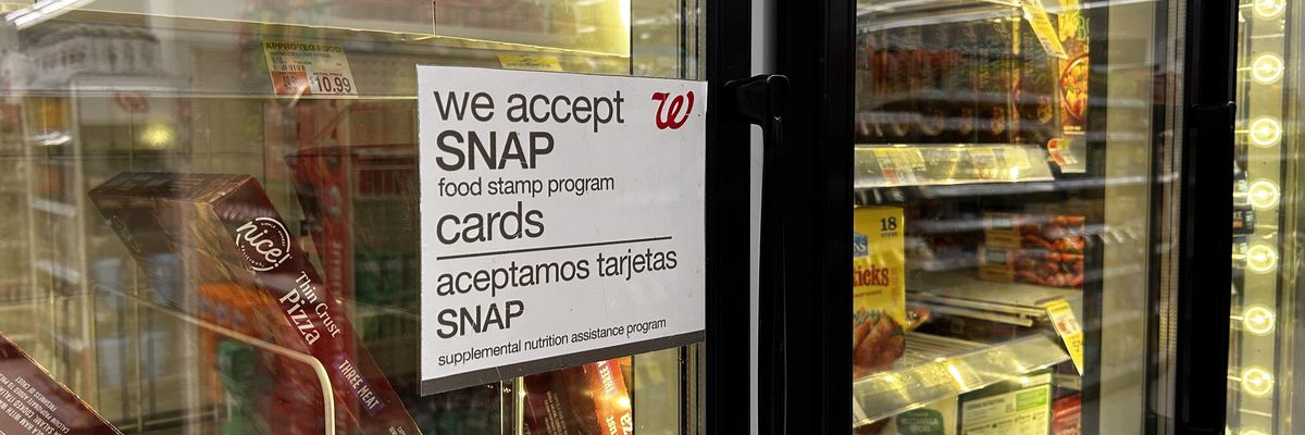 Bilingual sign on door of frozen food aisle, We accept SNAP food stamp cards, Walgreens, Queens, New York