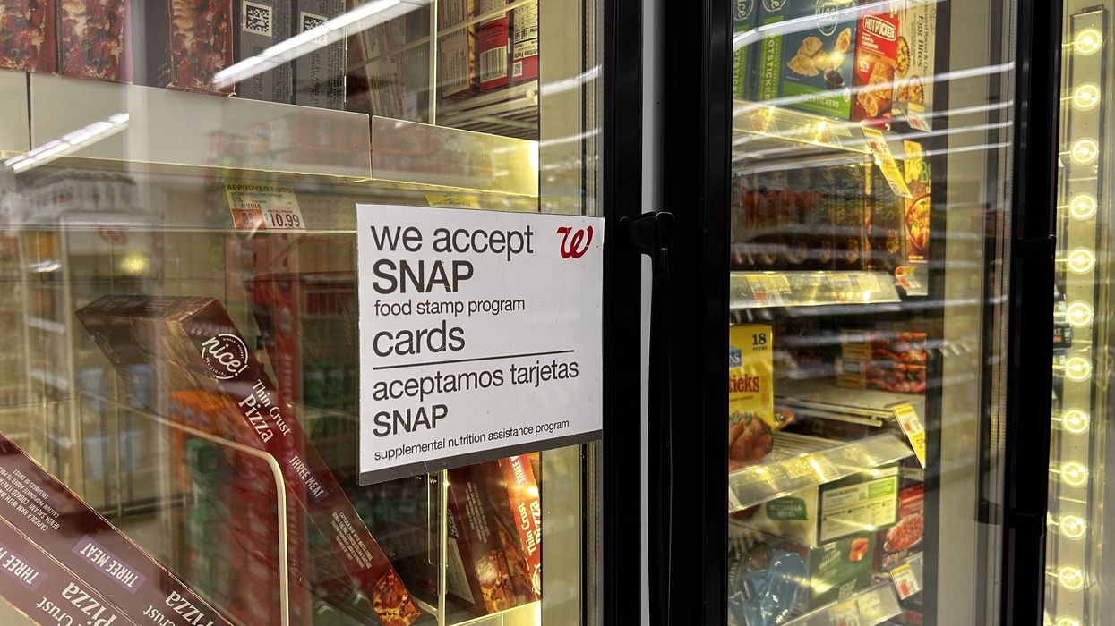 Bilingual sign on door of frozen food aisle, We accept SNAP food stamp cards, Walgreens, Queens, New York