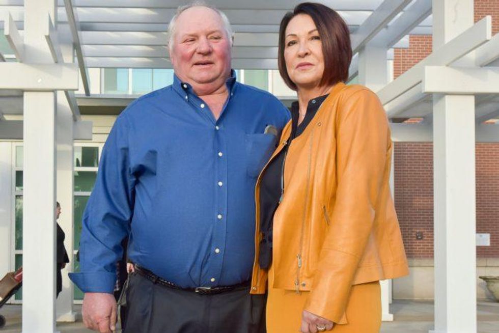 Bill Bader, owner of Bader Farms, and his wife Denise pose in front of the Rush Hudson Limbaugh Sr. United States Courthouse in Cape Girardeau, Missouri, on Monday, Jan. 27, 2020. (Photo by Johnathan Hettinger/Midwest Center for Investigative Reporting)