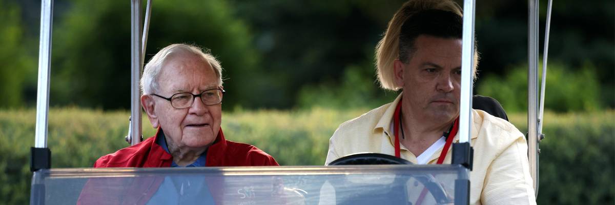 Billionaire Warren Buffett rides in a golf cart in Idaho