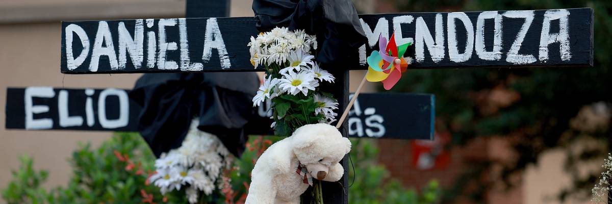 Black crosses with names and flowers.