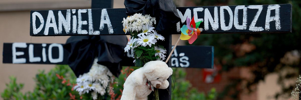 Black crosses with names and flowers.