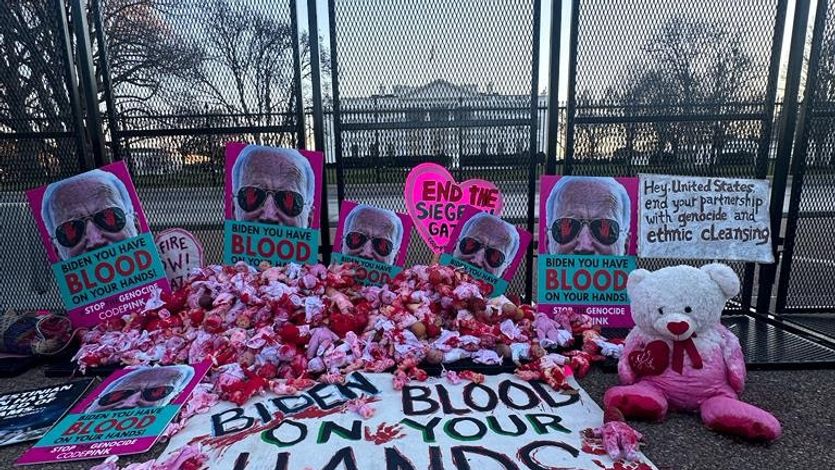 Bloodied baby dolls and sign that reads "Biden, Blood on Your Hands"
