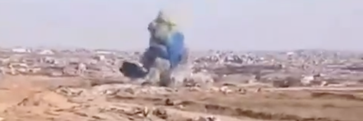 Blue smoke rises up from a bombing carried out by the Israel Defense Forces