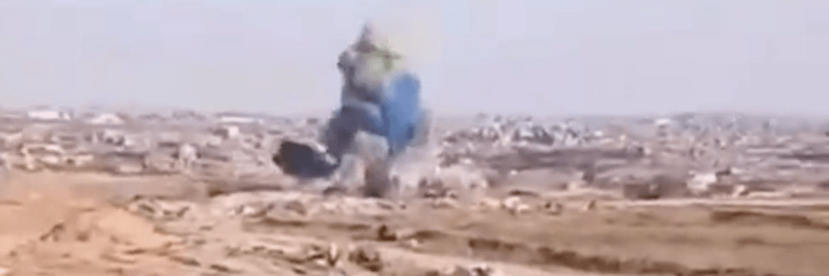 Blue smoke rises up from a bombing carried out by the Israel Defense Forces