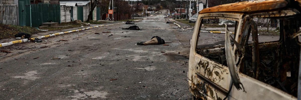 Bodies lie on a street in Bucha, northwest of Kyiv, on April 2, 2022, as Ukraine says Russian forces are making a "rapid retreat" from northern areas around Kyiv and the city of Chernigiv.