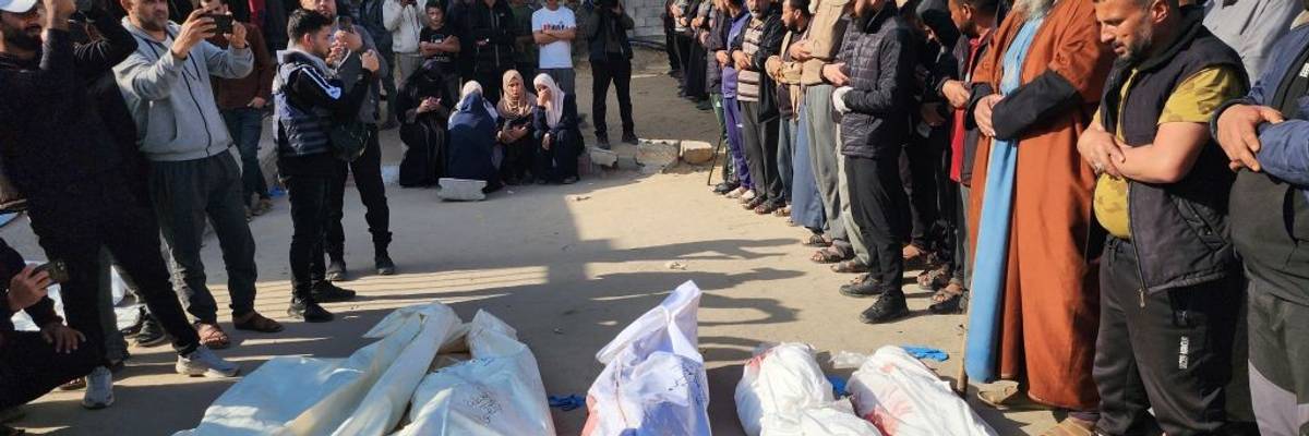 Bodies of Palestinians killed in renewed Israeli strikes are seen wrapped white sheets