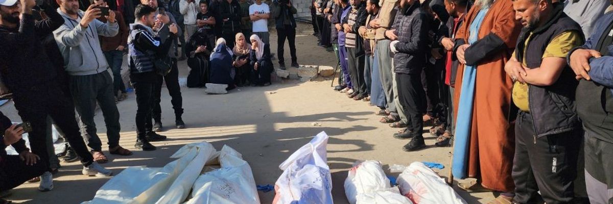 Bodies of Palestinians killed in renewed Israeli strikes are seen wrapped white sheets